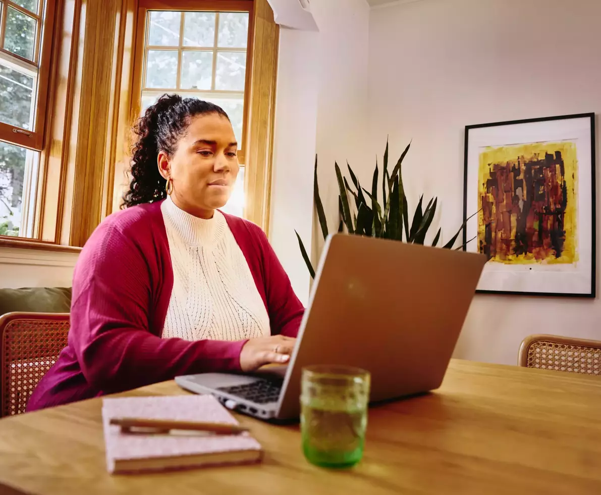 female sitting before her laptop